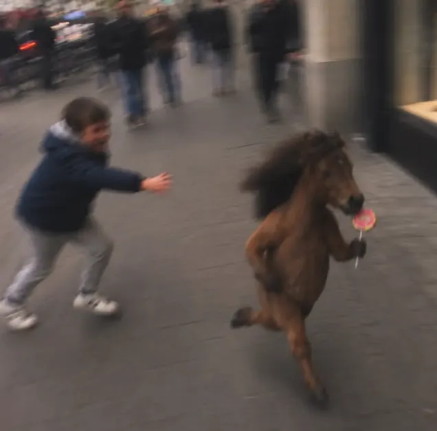 Un chico corriendo detrás de un caballo en miniatura con un chupetín